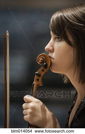 Picture - Serious woman holding violin. Fotosearch