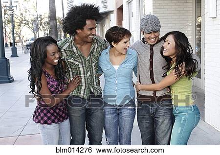 Smiling friends standing together hugging View Large Photo Image Stock Photograph - Smiling friends standing together hugging. Fotosearch