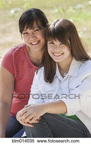 Smiling mother and daughter outdoors View Large Photo Image Stock Photography - Smiling mother and daughter outdoors. Fotosearch