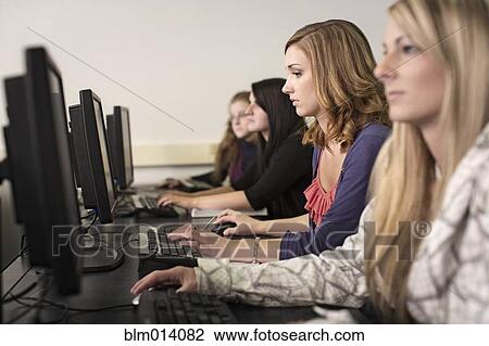 Stock Image - Students studying in computer lab. Fotosearch