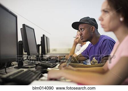 Stock Image - Students studying in computer lab. Fotosearch