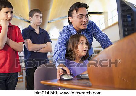 Teacher showing student how to use computer View Large Photo Image Stock Photo - Teacher showing student how to use computer. Fotosearch