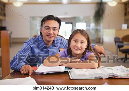 Teacher talking to student in library View Large Photo Image Stock Image - Teacher talking to student in library. Fotosearch