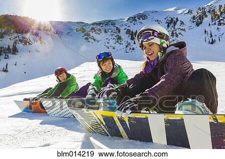 Stock Photo - Teenagers snowboarding together. Fotosearch
