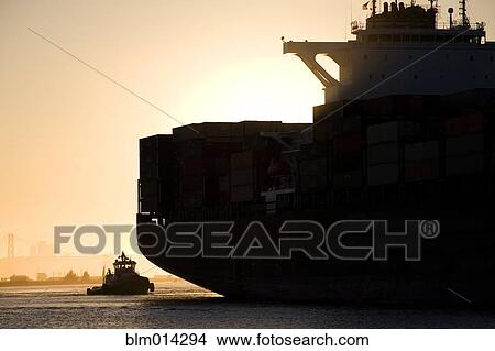 Picture - Tugboat and container ship in port of Oakland. Fotosearch