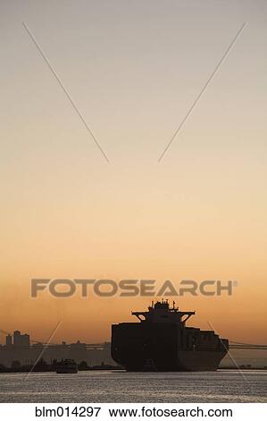 Stock Photo - Tugboat and container ship in port of Oakland. Fotosearch