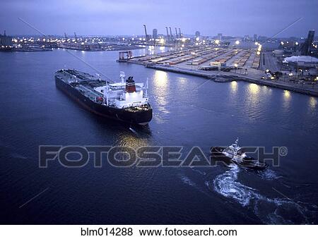 Stock Photo - Tugboat and container ship in the port of Long Beach. Fotosearch