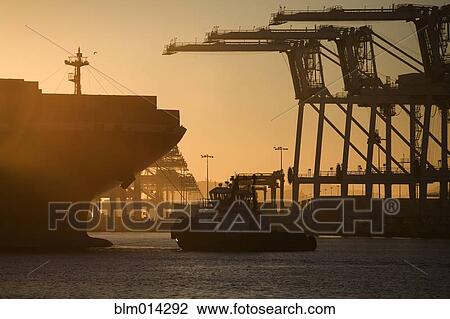Stock Image - Tugboat and container ship of port of Oakland. Fotosearch