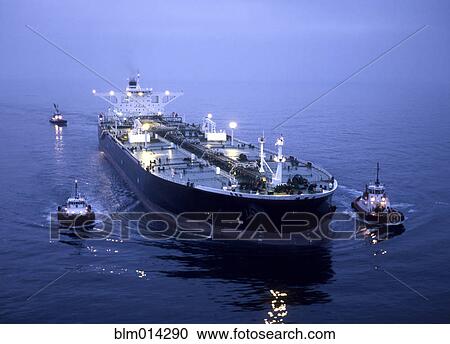 Stock Image - Tugboats and container ship in the port of Long Beach. Fotosearch