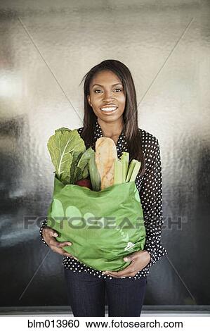 Woman carrying bag of groceries View Large Photo Image Stock Image - Woman carrying bag of groceries. Fotosearch