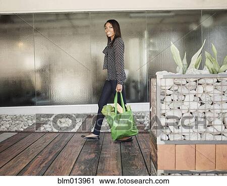 Woman carrying bag of groceries View Large Photo Image Stock Image - Woman carrying bag of groceries. Fotosearch