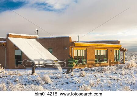 Woman taking snow off solar panel View Large Photo Image Stock Photography - Woman taking snow off solar panel. Fotosearch