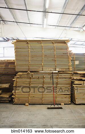 Stock Image - Wooden pallets in factory warehouse. Fotosearch