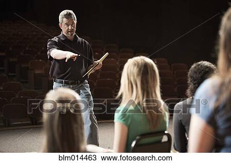 Stock Image - Actors rehearsing on stage. Fotosearch
