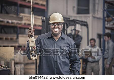 African American worker holding control panel in factory View Large Photo Image Stock Image - African American worker holding control panel in factory. Fotosearch