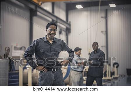 African American worker standing in factory View Large Photo Image Picture - African American worker standing in factory. Fotosearch