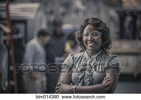 African American worker standing in factory View Large Photo Image Stock Image - African American worker standing in factory. Fotosearch
