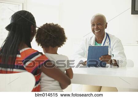 Stock Photography - Black doctor sitting with mother and girl. Fotosearch