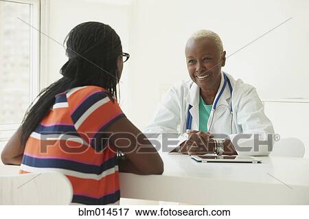 Black doctor talking to patient View Large Photo Image Stock Photo - Black doctor talking to patient. Fotosearch