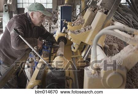 Carpenter working in woodshop View Large Photo Image Stock Image - Carpenter working in woodshop. Fotosearch