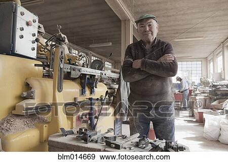 Carpenter working in woodshop View Large Photo Image Stock Photo - Carpenter working in woodshop. Fotosearch