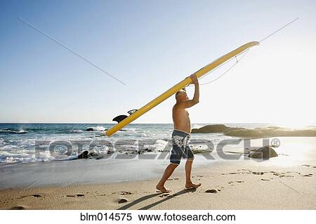 Caucasian man carrying paddleboard View Large Photo Image Stock Photography - Caucasian man carrying paddleboard. Fotosearch