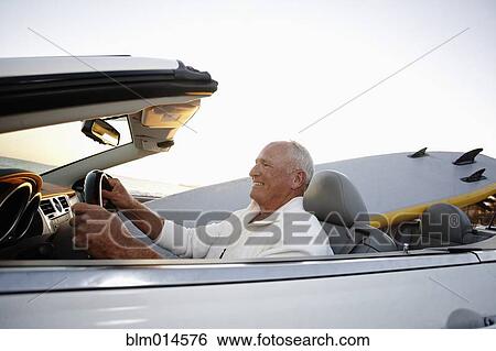 Caucasian man driving convertible View Large Photo Image Stock Photograph - Caucasian man driving convertible. Fotosearch