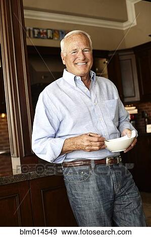 Caucasian man holding bowl View Large Photo Image Stock Photo - Caucasian man holding bowl. Fotosearch