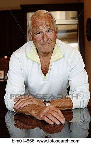 Stock Photograph - Caucasian man in kitchen. Fotosearch
