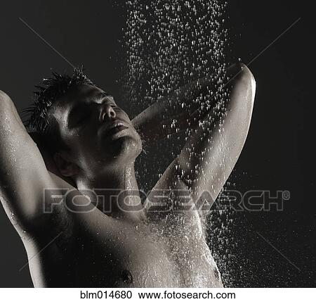 Stock Image - Caucasian man standing in shower. Fotosearch
