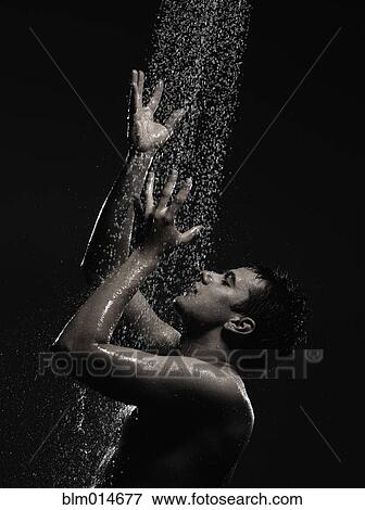 Stock Photo - Caucasian man standing in shower. Fotosearch