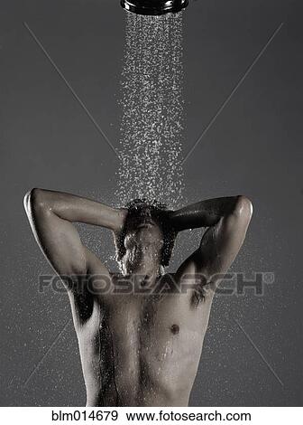 Stock Photo - Caucasian man standing in shower. Fotosearch