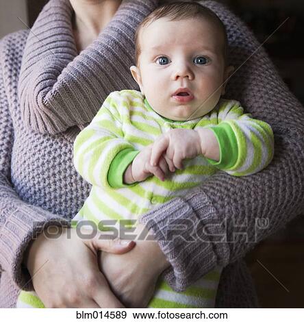 Caucasian mother holding baby boy View Large Photo Image Stock Photo - Caucasian mother holding baby boy. Fotosearch