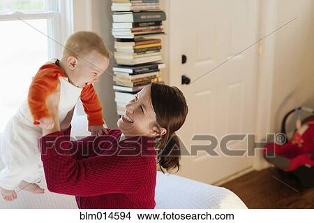 Picture - Caucasian mother playing with baby boy. Fotosearch