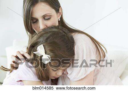 Stock Photography - Caucasian woman comforting daughter. Fotosearch