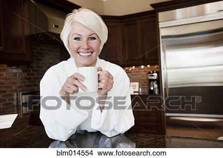 Caucasian woman in robe drinking coffee View Large Photo Image Picture - Caucasian woman in robe drinking coffee. Fotosearch