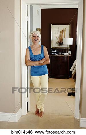 Caucasian woman leaning on wall with arms crossed View Large Photo Image Stock Photograph - Caucasian woman leaning on wall with arms crossed. Fotosearch