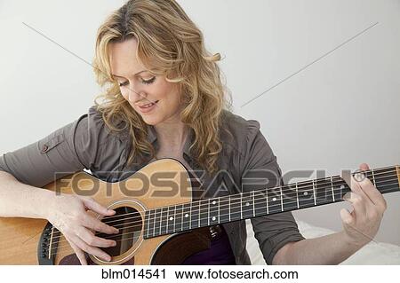 Caucasian woman playing guitar View Large Photo Image Stock Image - Caucasian woman playing guitar. Fotosearch