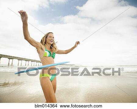 Caucasian woman using plastic hoop on beach View Large Photo Image Picture - Caucasian woman using plastic hoop on beach. Fotosearch