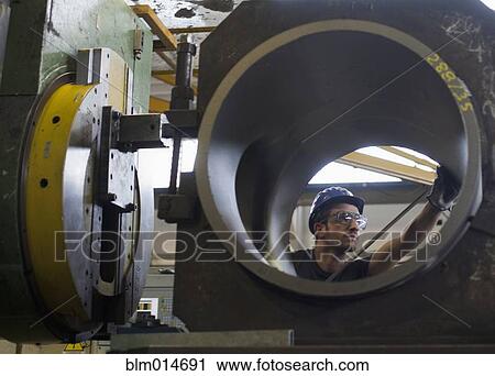 Caucasian worker working on steel pipe in factory View Large Photo Image Stock Image - Caucasian worker working on steel pipe in factory. Fotosearch