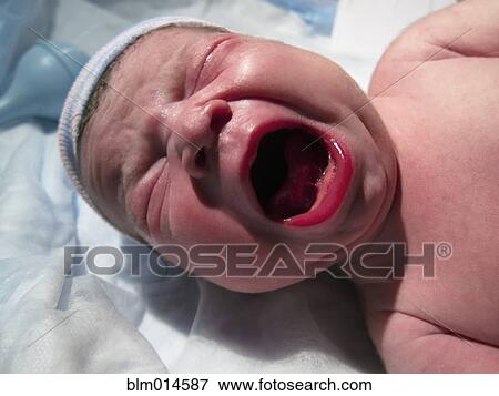 Stock Photo - Crying Caucasian newborn baby boy. Fotosearch