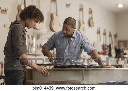 Stock Photo - Father and son in music workshop. Fotosearch