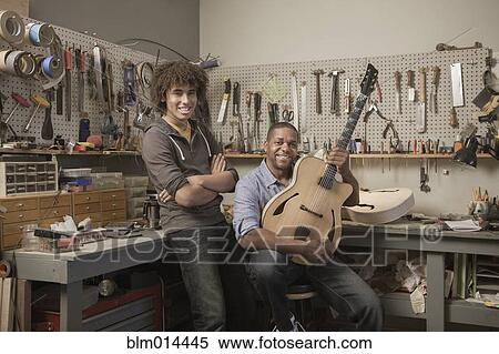 Stock Photography - Father and son in music workshop. Fotosearch