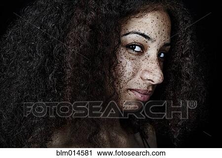 Stock Image - Freckled mixed race woman. Fotosearch