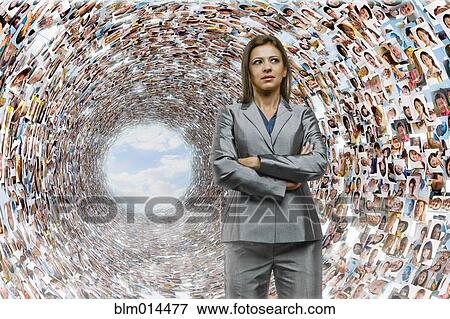 Stock Photo - Hispanic businesswoman surrounded by images of business people. Fotosearch