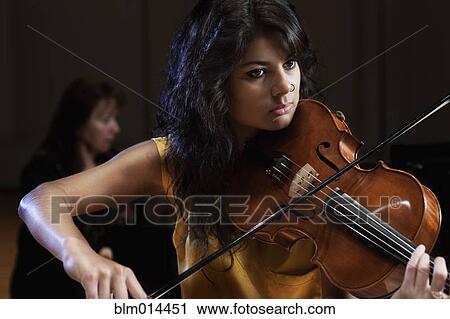 Hispanic woman playing violin View Large Photo Image Stock Image - Hispanic woman playing violin. Fotosearch