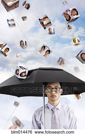 Stock Photograph - Images of business people falling on Korean businessman's umbrella. Fotosearch