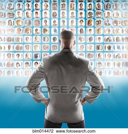 Stock Image - Images of business people floating in front of African American businessman. Fotosearch