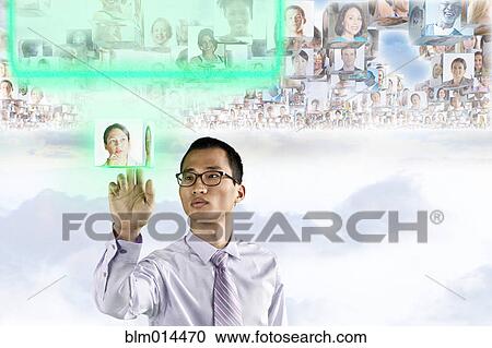 Stock Image - Images of business people floating above Korean businessman's head. Fotosearch