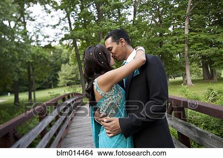 Picture - Indian wedding couple kissing on bridge. Fotosearch